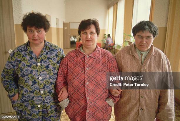 Three women walk down the hallway together at a local psychiatric hospital.