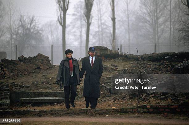 Movie Director/Producer Steven Spielberg and his wife walk through the Auschwitz-Birkenau concentration camp on a gloomy rainy day. Spielberg was in...