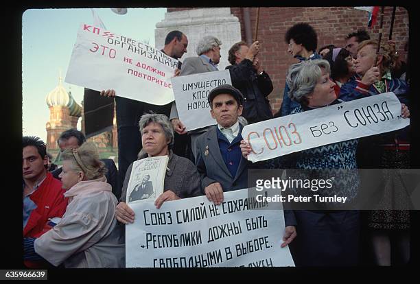 Demonstrators hold up signs stating "Union without Union" in a protest outside the Kremlin following the Soviet Coup attempt and shortly before the...