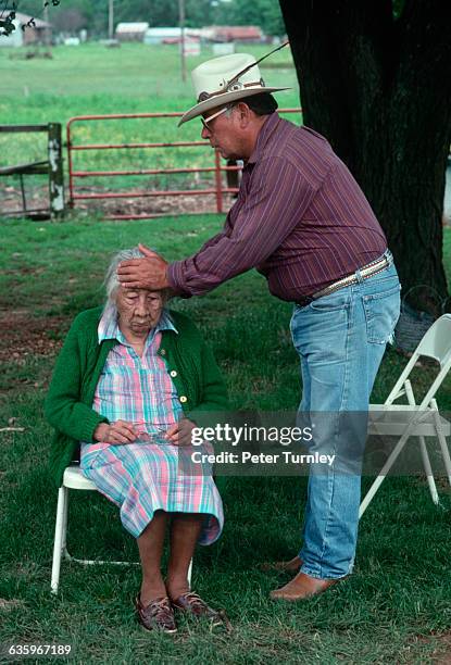 Cherokee medicine man Crosslin Smith attempts to a heal woman.
