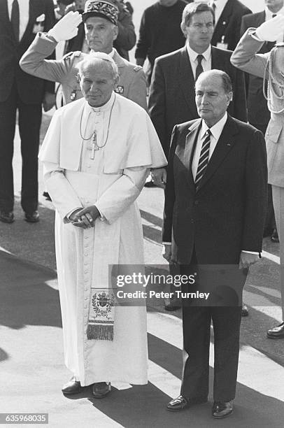 Pope John Paul II meets with French President Francois Mitterrand in Paris.