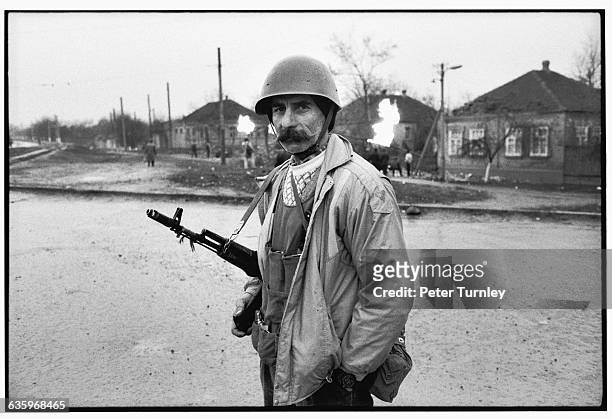 Chechnyan soldier stands about with his rifle during the Russian-Chechen war. As this picture was taken, Russian troops were invading the country in...