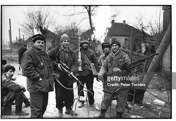 Chechnyan soldiers stand about with weapons during the Russian-Chechen war. As this picture was taken, Grozny was the target of Russian troops, who...