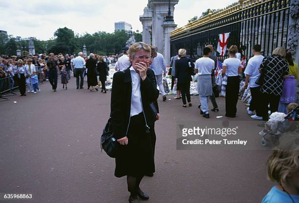 Woman cries as she stands at the gates of Buckingham Palace after the tragic automobile accident in Paris on August 31 in which Diana, Princess of...
