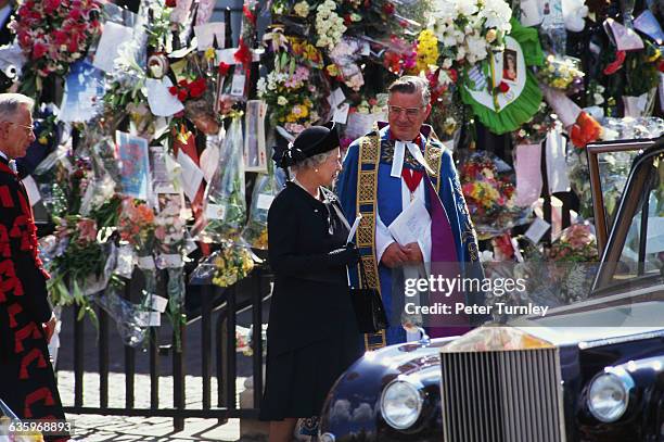 Queen Elizabeth stands with a priest at the funeral of Diana, Princess of Wales, only seven days after she was killed in an automobile accident in...