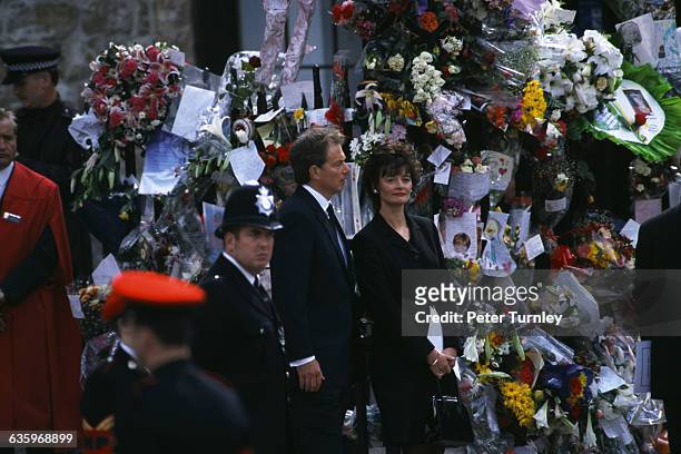 British Prime Minister Tony Blair and his wife Cherie stand at the funeral of Diana, Princess of Wales, only seven days after she was killed in an...