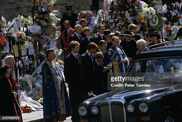 Earl Charles Spencer, the younger brother of Princess Diana, stands with Prince William, Prince Harry, Prince Charles, and various priests and guests...