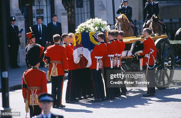 Guardsmen of the Prince of Wales Company of the Welsh Guards unload Diana's casket from a carriage during the funeral of Diana, Princess of Wales,...