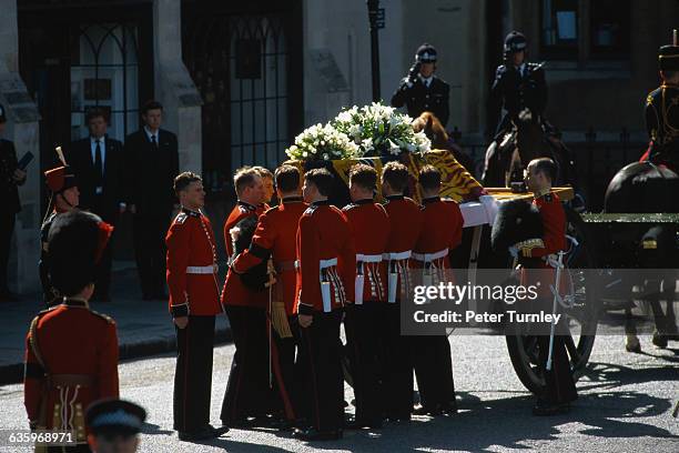 Guardsmen of the Prince of Wales Company of the Welsh Guards unload Diana's casket from a carriage during the funeral of Diana, Princess of Wales,...