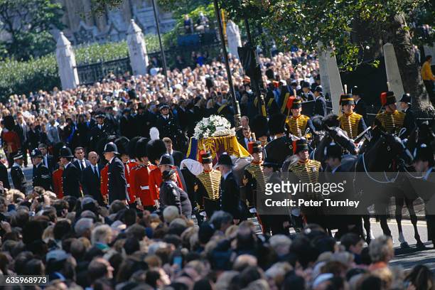 Guardsmen of the Prince of Wales Company of the Welsh Guards attend the casket along the route of the funeral procession of Diana, Princess of Wales,...