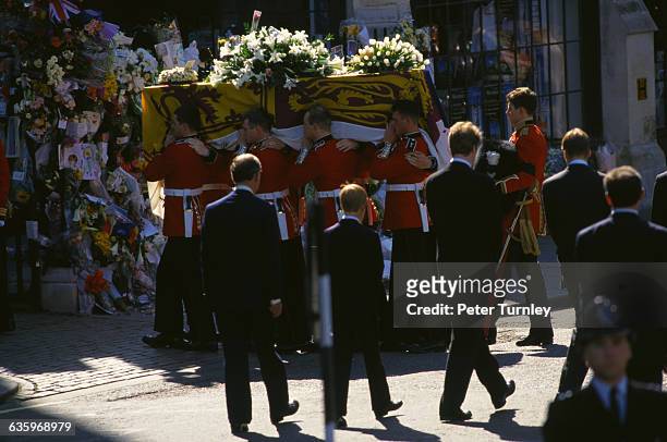Charles, Prince of Wales, Prince Harry, Earl Spencer, and Prince William walk behind Diana's casket during the funeral procession of Diana, Princess...