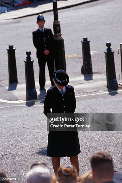 English "Bobbies" watch the crowds along the route of the funeral procession of Diana, Princess of Wales, who was killed in a tragic automobile...