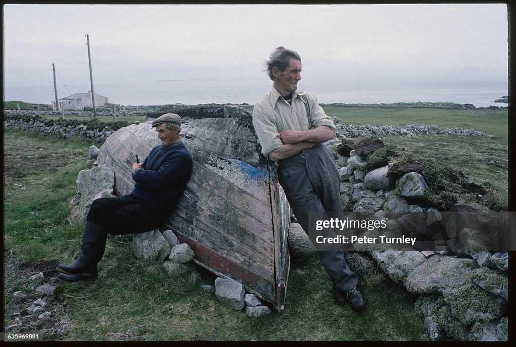 Irish Men Leaning Against a Wooden Boat