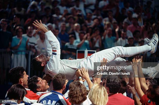 Philippe Omnes is held aloft by fans after a 1992 Olympic fencing final. | Location: Barcelona, Spain.