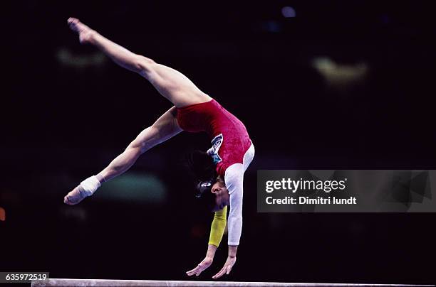 Chinese gymnast Mao Yanling performs a hand leap on the balance beam during the women's team finals at the 1996 Olympic Games.