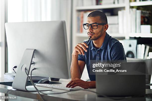 learning the ropes of his industry through first-hand experience - desktop pc home office stock pictures, royalty-free photos & images
