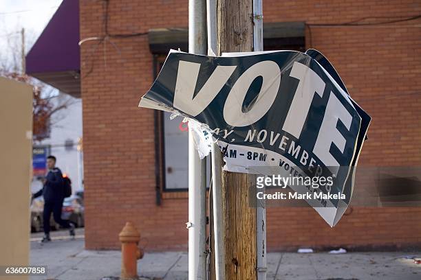 Vote sign hangs ripped from a telephone pole three weeks after election day December 1, 2016 in Philadelphia, Pennsylvania. Republican Presidential...