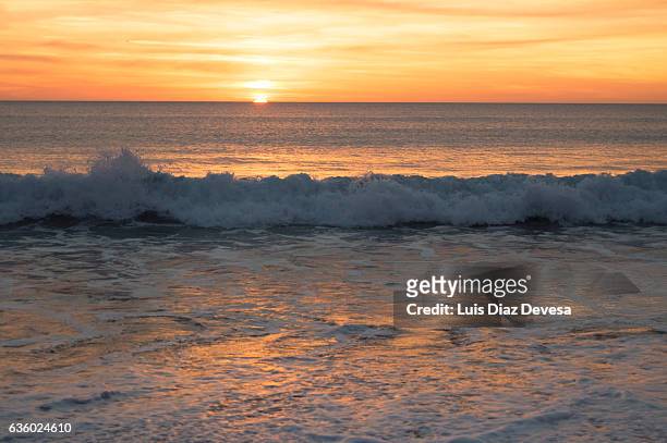 sunset over the beach - sunset beach stockfoto's en -beelden