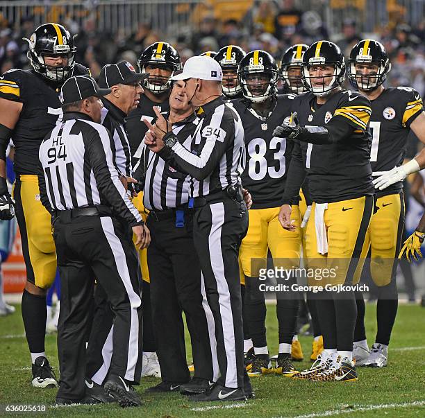 Quarterback Ben Roethlisberger of the Pittsburgh Steelers gestures as game officials, head linesman Hugo Cruz, referee Clete Blakeman, side judge Joe...