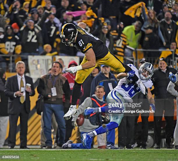 Tight end Jesse James of the Pittsburgh Steelers falls forward after leaping over safety Jeff Heath of the Dallas Cowboys during a game at Heinz...