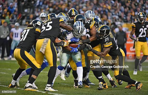 Running back Ezekiel Elliott of the Dallas Cowboys is tackled by linebacker Arthur Moats, safeties Mike Mitchell and Robert Golden and cornerback...