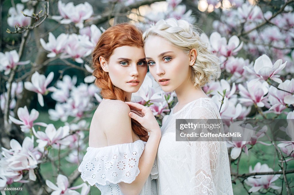 Beautiful girls on the background of spring bush