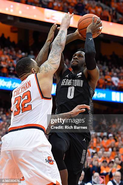 Peak of the Georgetown Hoyas shoots the ball as DaJuan Coleman of the Syracuse Orange defends during the first half at the Carrier Dome on December...