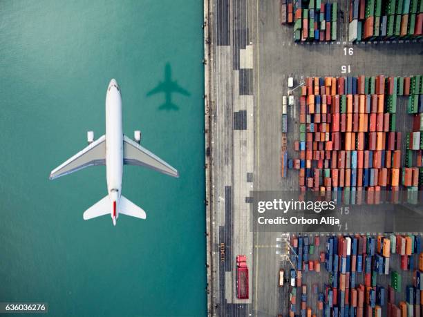 airplane flying over container port - luftfarkost bildbanksfoton och bilder