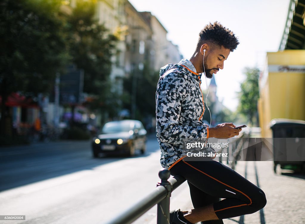 Man taking a break after running session in city