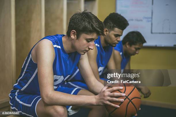 high school basketball team in locker room - high school locker room stock pictures, royalty-free photos & images