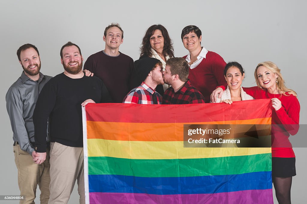Group of LGBT advocates holding pride flag