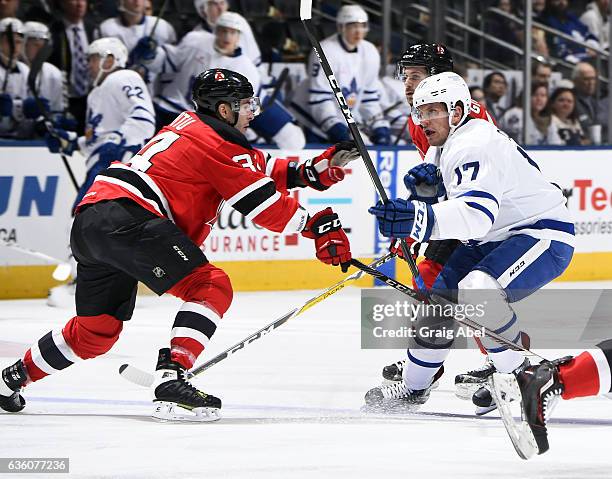 Rich Clune of the Toronto Marlies battles with Yohann Auvitu of the Albany Devils during AHL game action on December 17, 2016 at Air Canada Centre in...