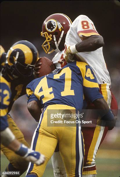 Wide Receiver Art Monk of the Washington Redskins gets tackled by LeRoy Irvin of the Los Angeles Rams during an NFL game November 20, 1983 at Anaheim...