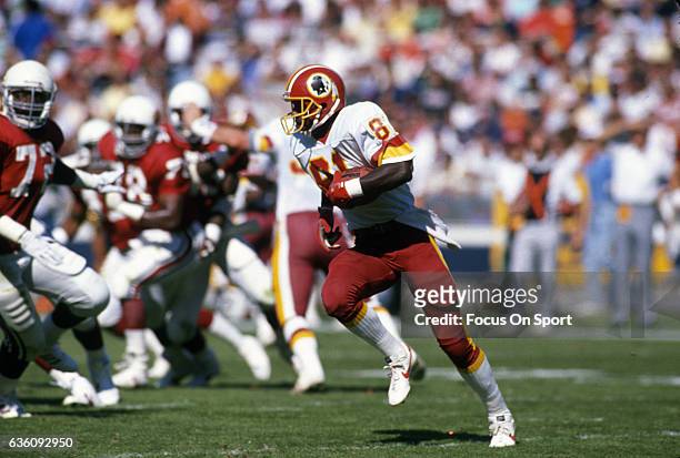 Wide Receiver Art Monk of the Washington Redskins runs with the ball after catching a pass against the St. Louis Cardinals during an NFL game October...