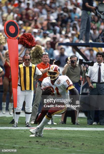 Wide Receiver Art Monk of the Washington Redskins runs with the ball during an NFL game circa 1988 at RFK Stadium in Washington, D.C. Monk played for...