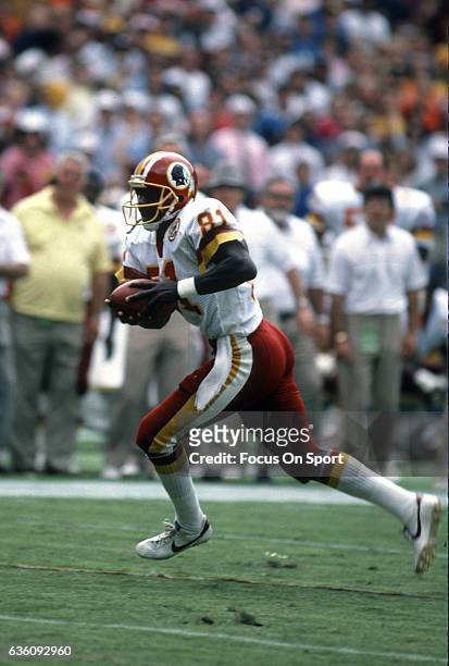 Wide Receiver Art Monk of the Washington Redskins runs with the ball during an NFL game circa 1988 at RFK Stadium in Washington, D.C. Monk played for...