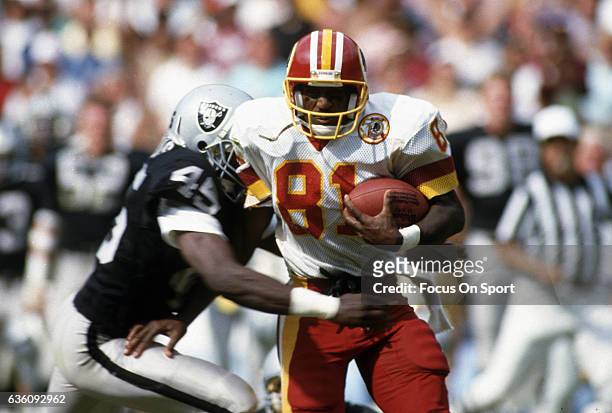 Wide Receiver Art Monk of the Washington Redskins runs with the ball after catching a pass against the Los Angeles Raiders during an NFL game circa...