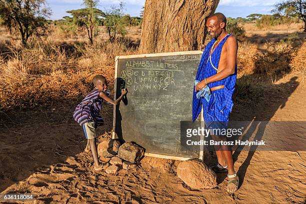 african children in the school under tree, kenya, east africa - kenyansk kultur bildbanksfoton och bilder