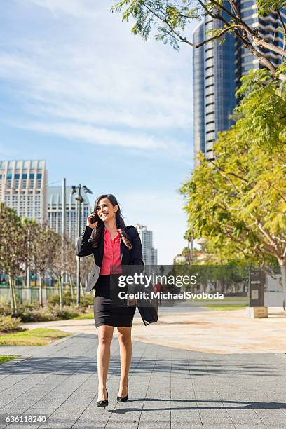 hispanic business women walking downtown san diego - downtown san diego stock pictures, royalty-free photos & images