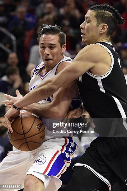 McConnell of the Philadelphia 76ers is pressured by Jeremy Lin of the Brooklyn Nets during the fourth quarter at the Wells Fargo Center on December...