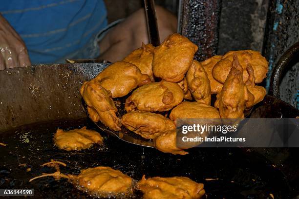 Man Taking Out Fried Bhajjis From Oil.