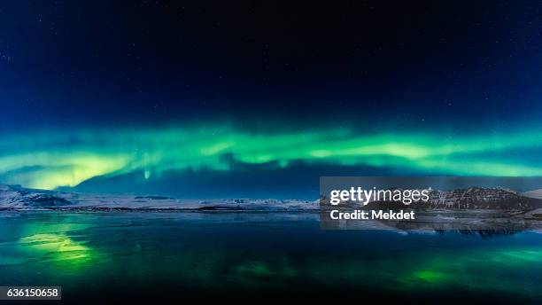 aurora borealis or northern lights over jokulsarlon, iceland - jokulsarlon lagoon ストックフォトと画像