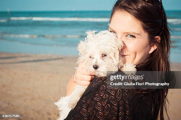 young woman and her puppy - brown hair blue eyes and dimples stock pictures, royalty-free photos & images