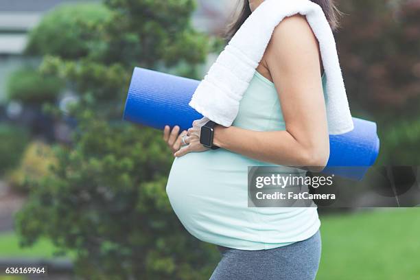 ethnic pregnant mother waiting to do yoga outside - prenatal yoga stock pictures, royalty-free photos & images