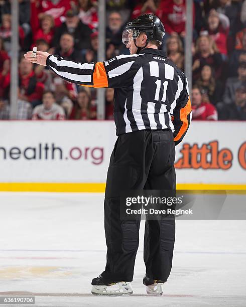 Referee Kelly Sutherland points to center ice for a good goal after a video review during an NHL game between the Detroit Red Wings and the Anaheim...