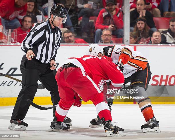 Linesman Devin Berg drops the puck between Frans Nielsen of the Detroit Red Wings and Ryan Kesler of the Anaheim Ducks during an NHL game at Joe...