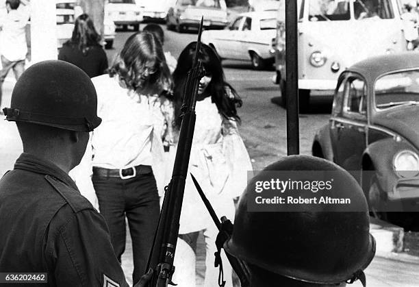 Students walk through People's Park as guards hold their riffles circa May, 1969 in Berkeley, California.