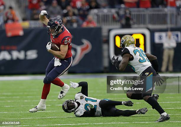 Ryan Griffin of the Houston Texans hurdles Prince Amukamara of the Jacksonville Jaguars as Tashaun Gipson pursues at NRG Stadium on December 18, 2016...