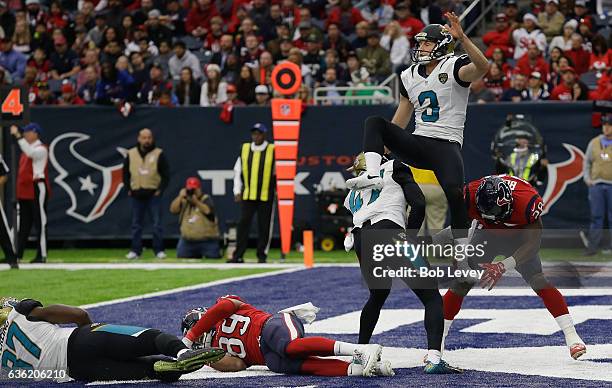 Brad Nortman of the Jacksonville Jaguars takes a hit from Alfred Blue of the Houston Texans at NRG Stadium on December 18, 2016 in Houston, Texas.