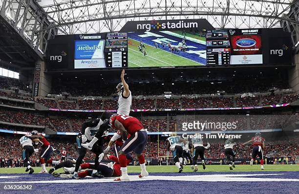 Brad Nortman of the Jacksonville Jaguars is hit during a punt against the Houston Texans in the second quarter at NRG Stadium on December 18, 2016 in...